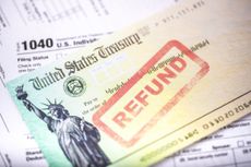 Tax refund check stamped "refund" on top of Form 1040