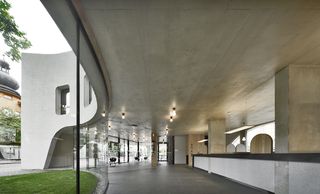 Wide walkway inside concrete building with concrete ceiling