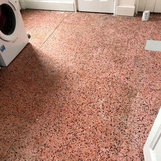 kitchen spotted tiles with washing machine and white door