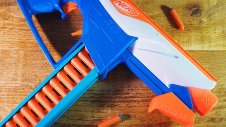 A Nerf N-Series Infinite blaster lying on a wooden table