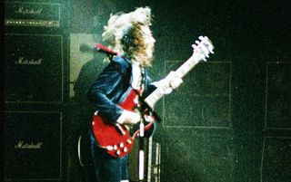 Angus Young performs with AC/DC in July 1983 at Madison Square Garden in New York City