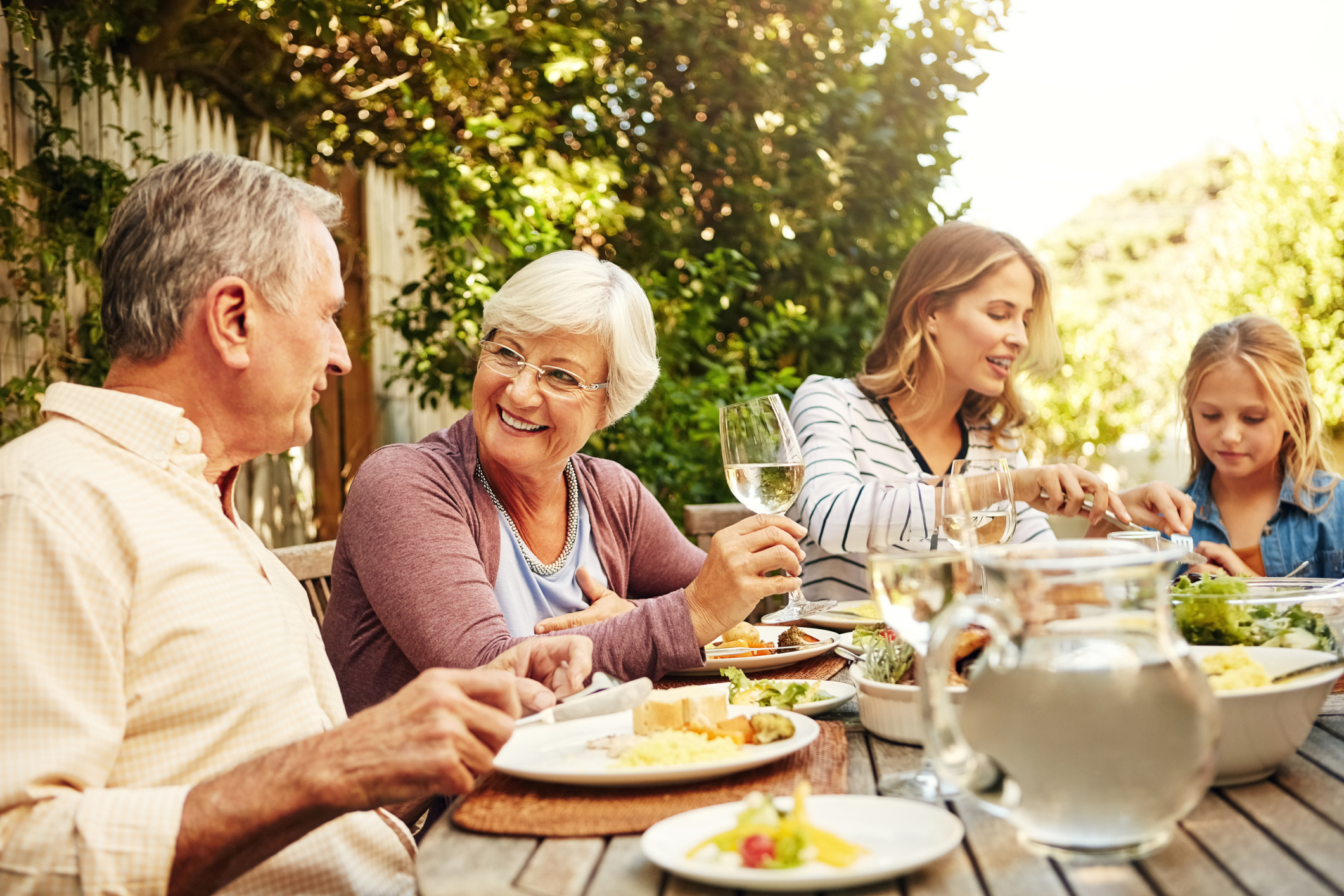 Shot of a family eating lunch together outdoors