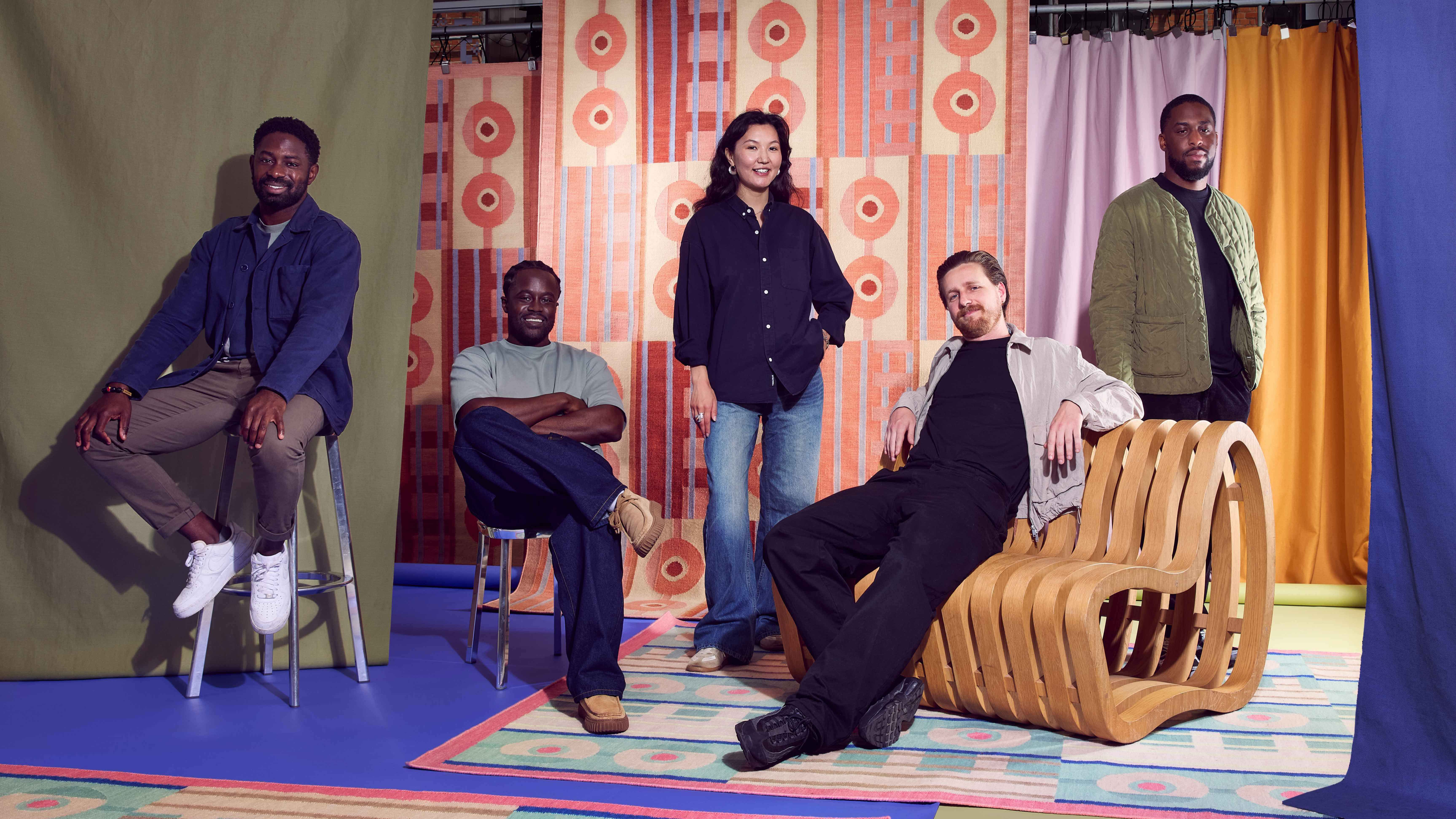 POoR Collective in front of colourful geometric rug designs for Floor Story