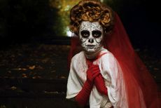 Woman in Day of the Dead or Halloween face paint. 