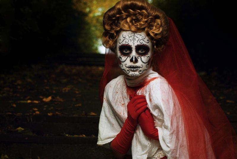 Woman in Day of the Dead or Halloween face paint. 