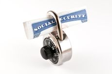 A social security card inside a combination lock. 