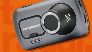 A Nextbase dash cam on an orange background