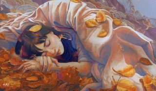 A woman sleeping under a duvet with leaves