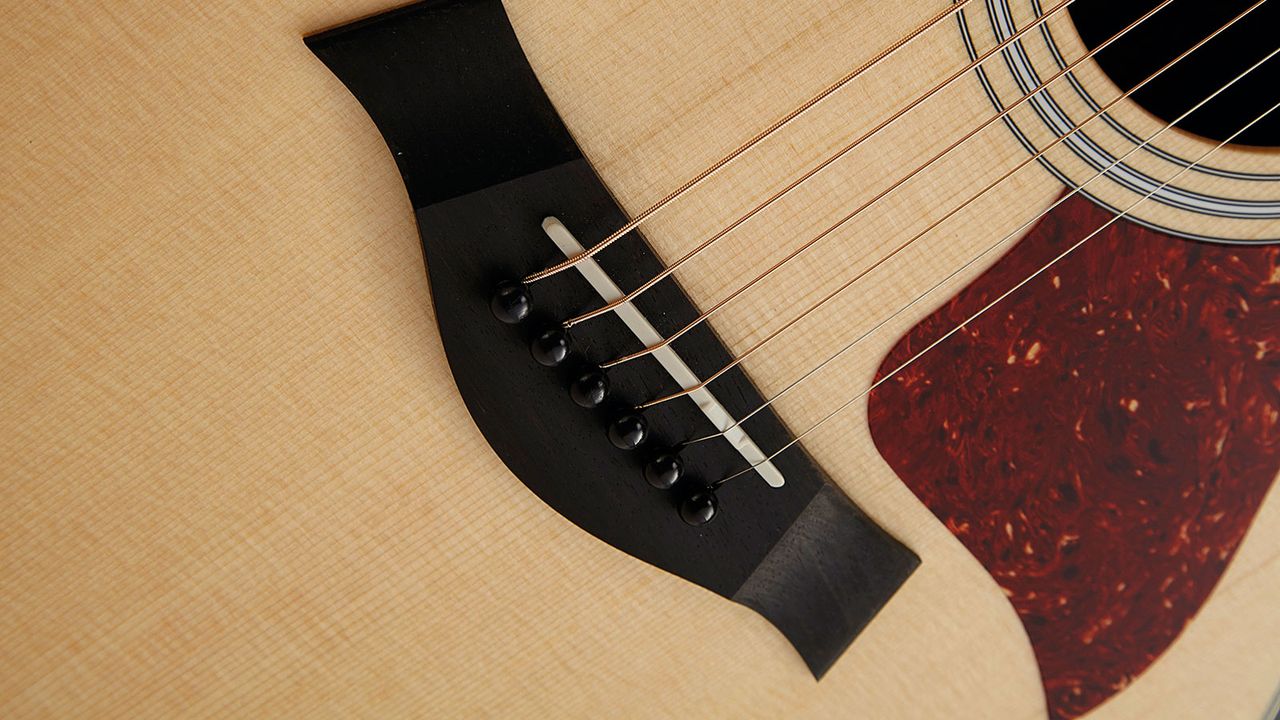 The 214ce has an Ebony bridge and compensated Tusq saddle, with 56mm spacing