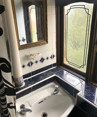 Dated bathroom with tiling around basin
