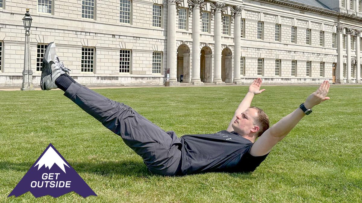 Personal trainer Ollie Thompson training outside on the grass with a building in the background