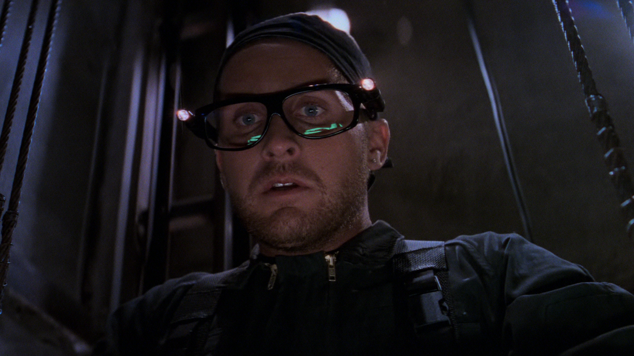 Emilio Estevez with large glasses in an elevator shaft in Mission: Impossible