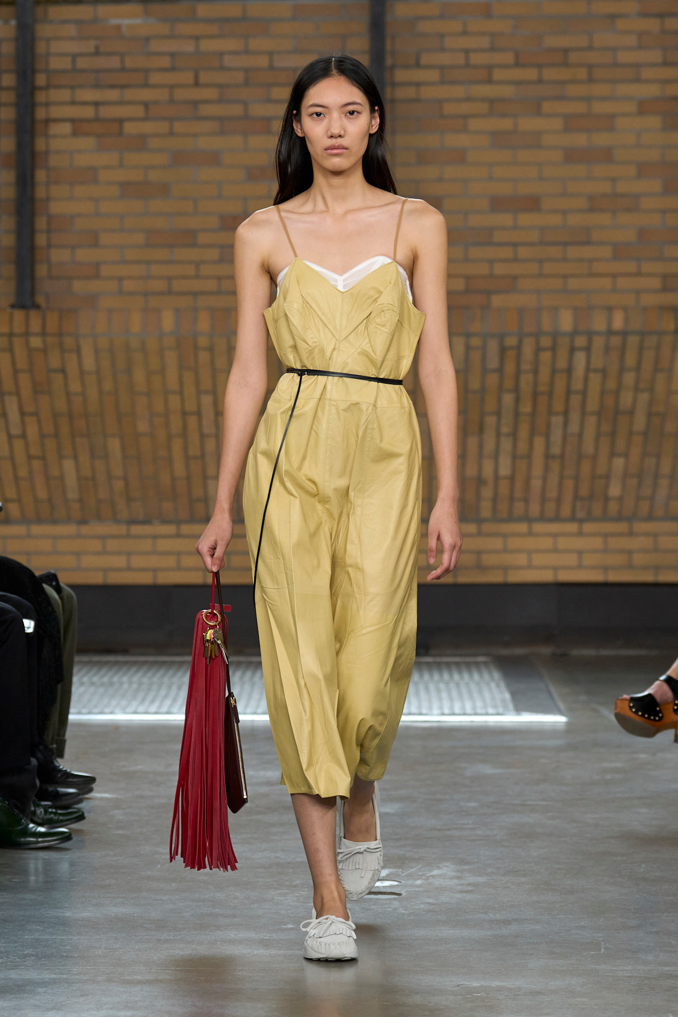 A model wore buter yellow and burgundy on the Calvin Klein Spring 2026 runway