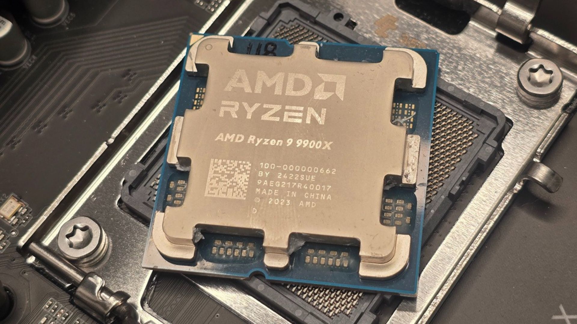 A close up of the AMD Ryzen 9 9900X CPU on its motherboard socket