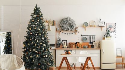 Christmas tree decorated in modern kitchen