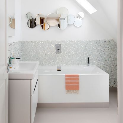 white attic bathroom idea with mirrored tiling