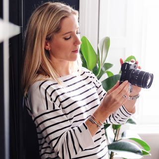 room with girl with camera and plant