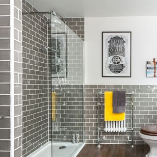 bathroom with grey with white tiled walls and shower room