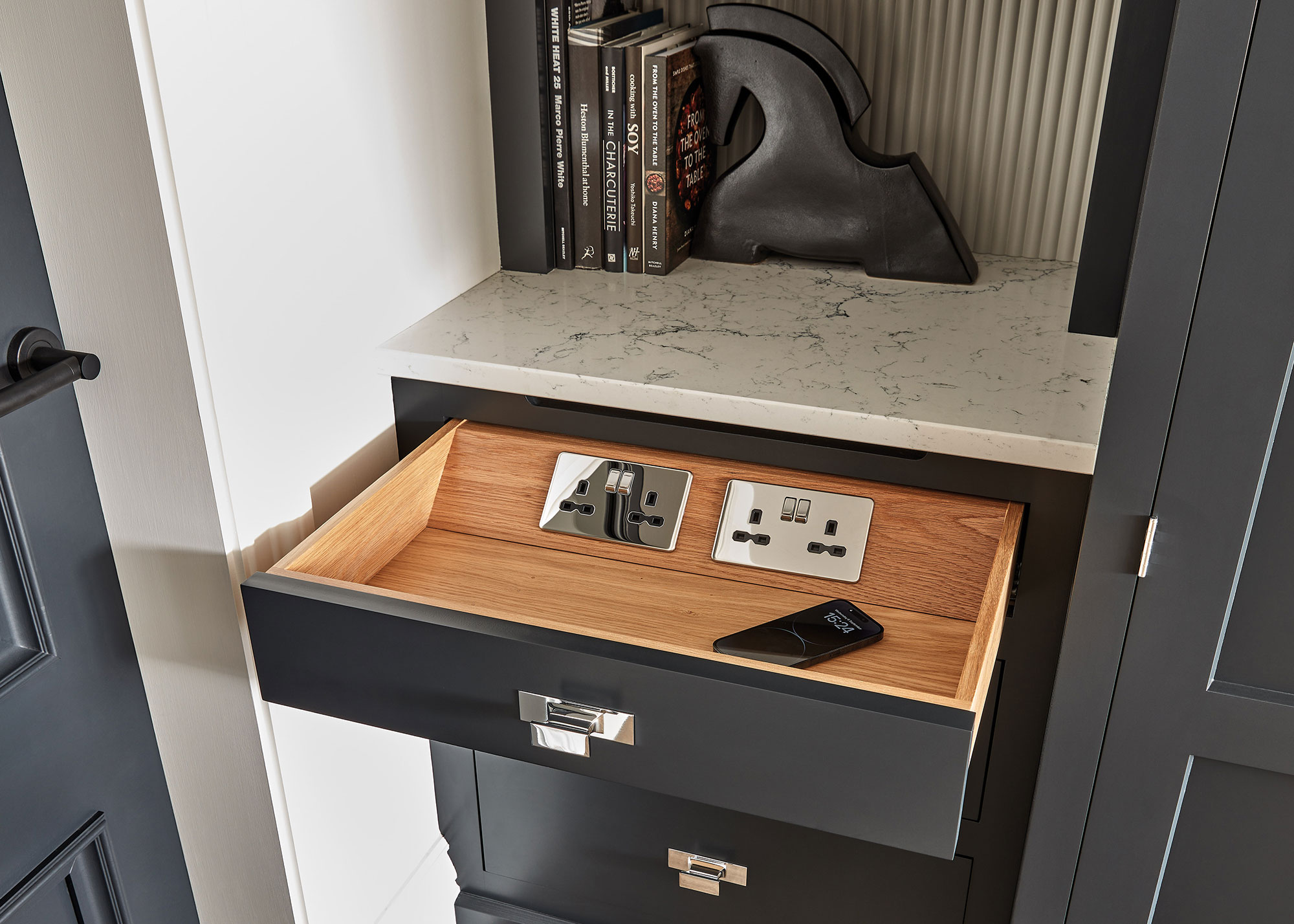 grey kitchen drawer with chrome electric socketes