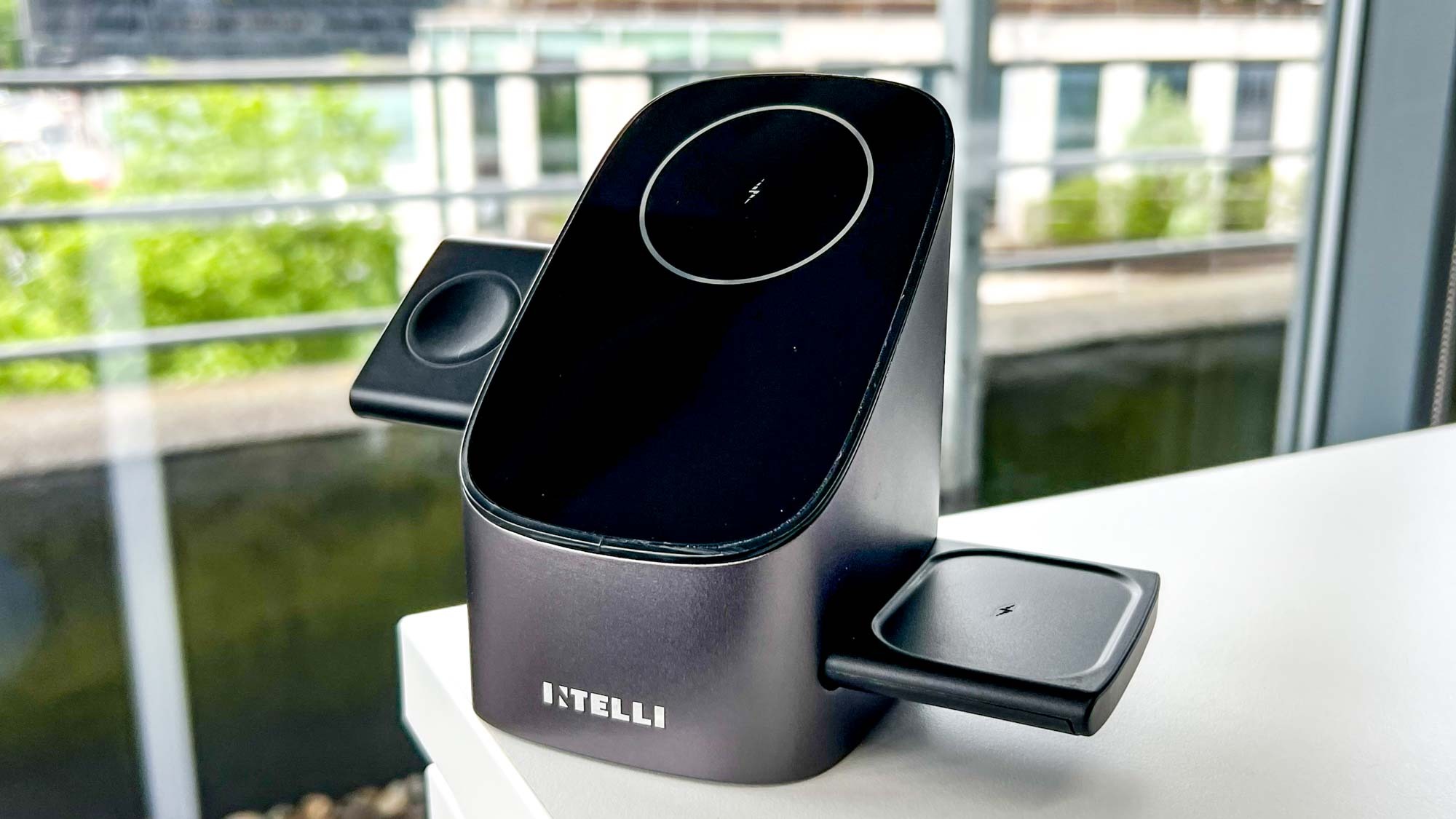 The Intelli StepUp wireless charger on a desk near a window