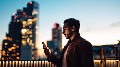 Man looking at phone in the City