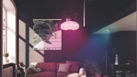 best smart bulb LIFX Color A19 in pink used in dark living room area above sofa