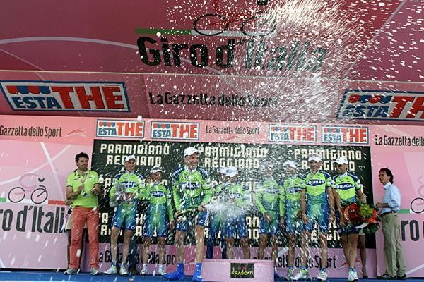 Watch from a safe distance - the first of many Champagne bottles is emptied over Giro spectators.