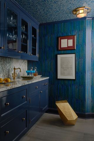 blue kitchen corner with marble counter, wallpaper on walls and ceiling
