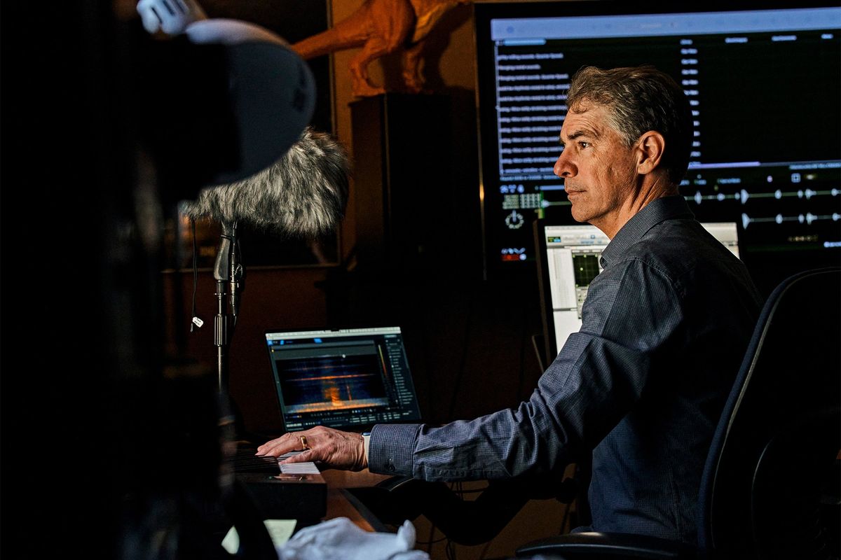 Man in room using Mac to create sounds