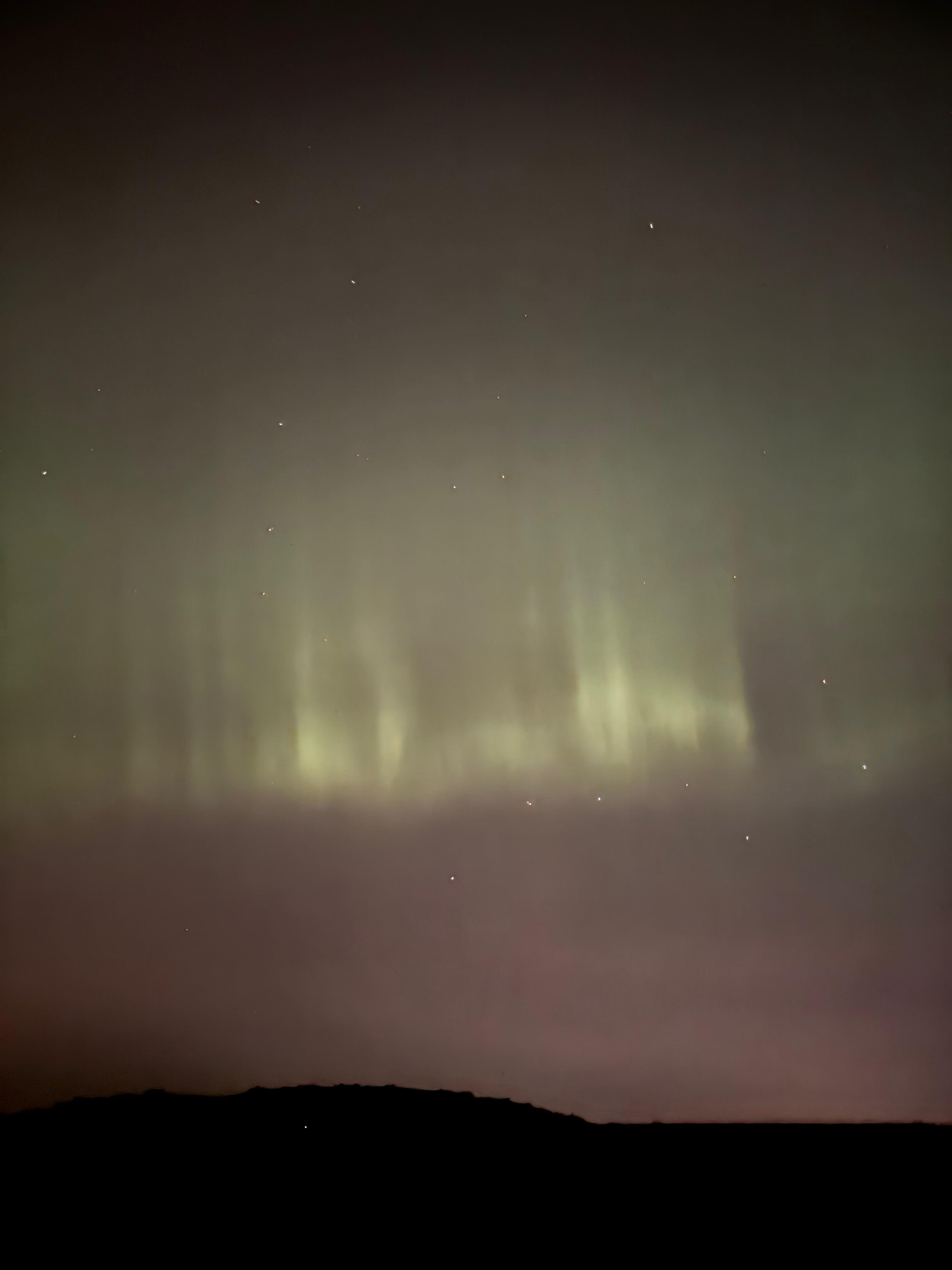 The Northern Lights' green pillars in the sky