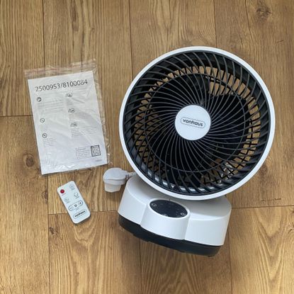 Vonhaus Air Circulator Cooling Fan on a wooden floor next to the remote control and instruction manual