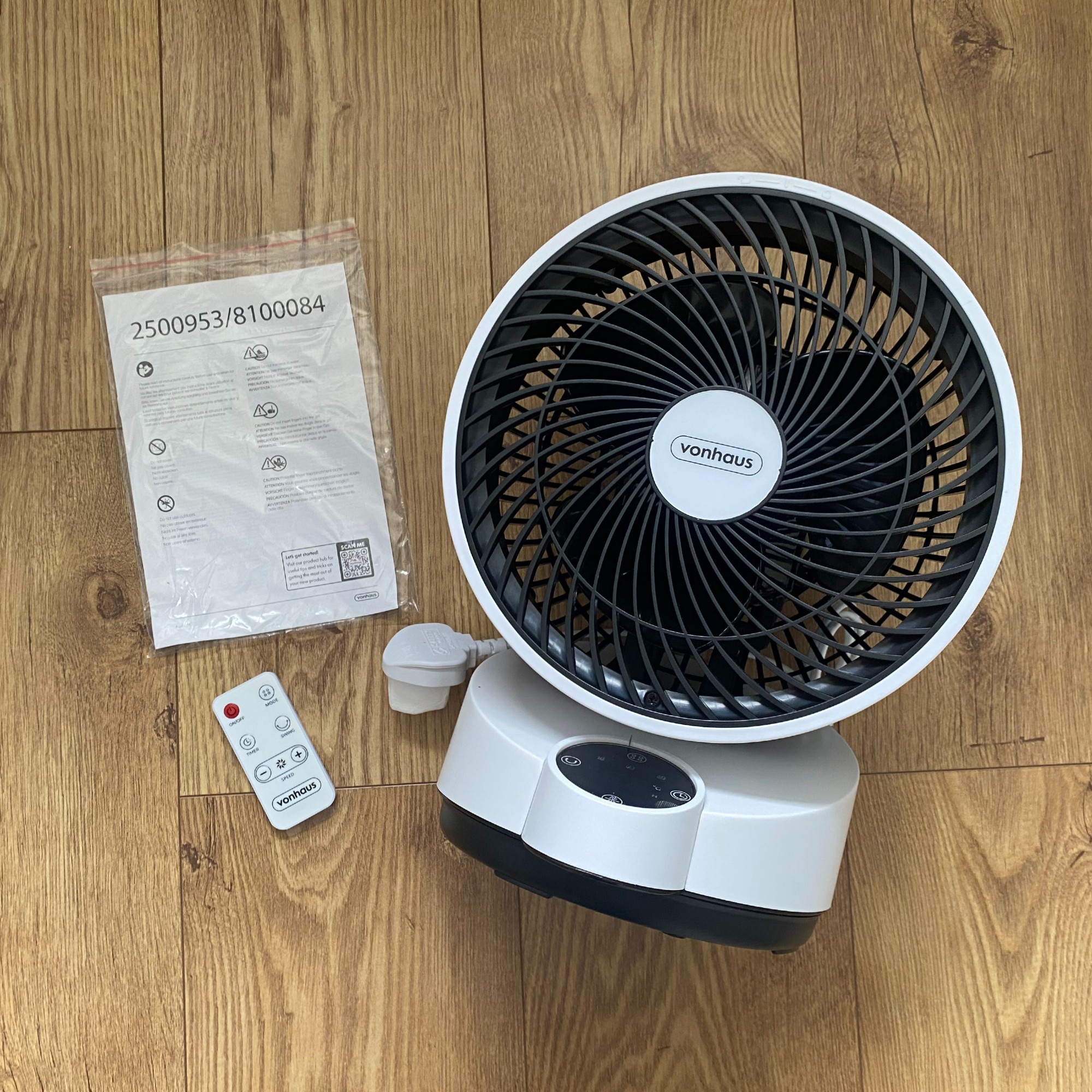 Vonhaus Air Circulator Cooling Fan on a wooden floor next to the remote control and instruction manual
