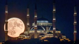 The full moon rises behind Istanbul's Camlica Mosque on August 01, 2023 in Istanbul,