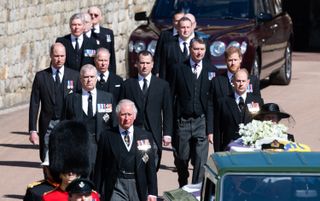 The Duke of Edinburgh’s coffin, covered with His Royal Highness’s Personal Standard is seen on the purpose built Land Rover, followed by members of the Royal Family