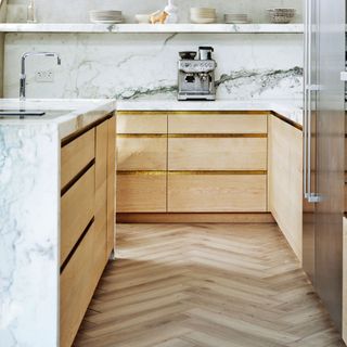 white marble kitchen with wooden laminate flooring