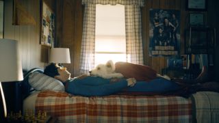 Clark Kent (David Corenswet) lies in bed with Krypto in Superman.