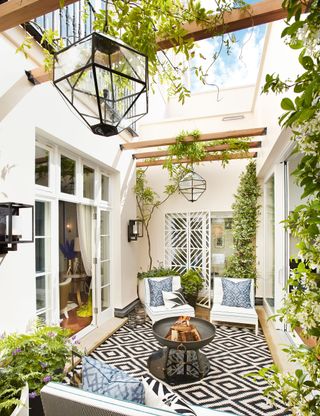 Small outdoor living room with rug, seating and patterned rug