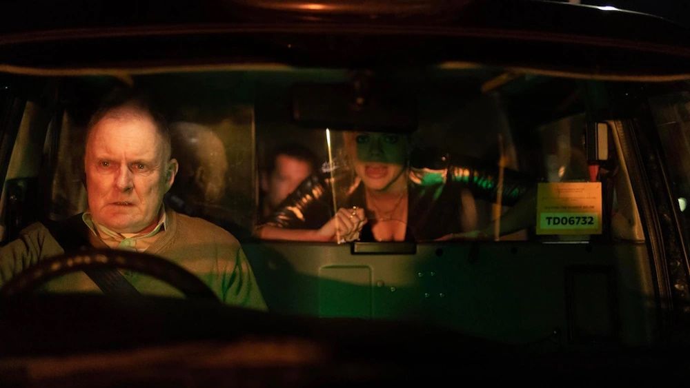 Robert Glenister as Tony driving a taxi with terrified looking people in the back in &#039;The Night Caller&#039;