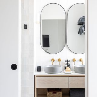 An ensuite bathroom with gold wall-mounted taps