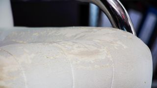 A damaged leather seat on an office chair