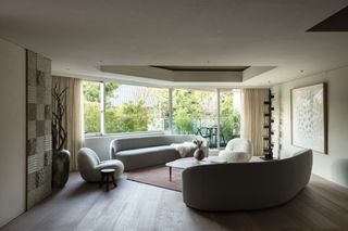 A living room with a curving sofa