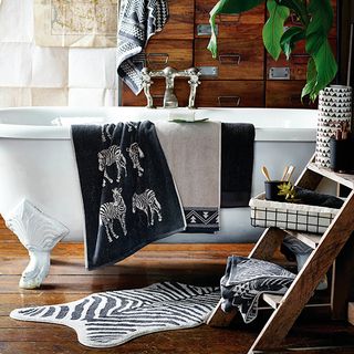 bathroom with bathtub and animal print towel