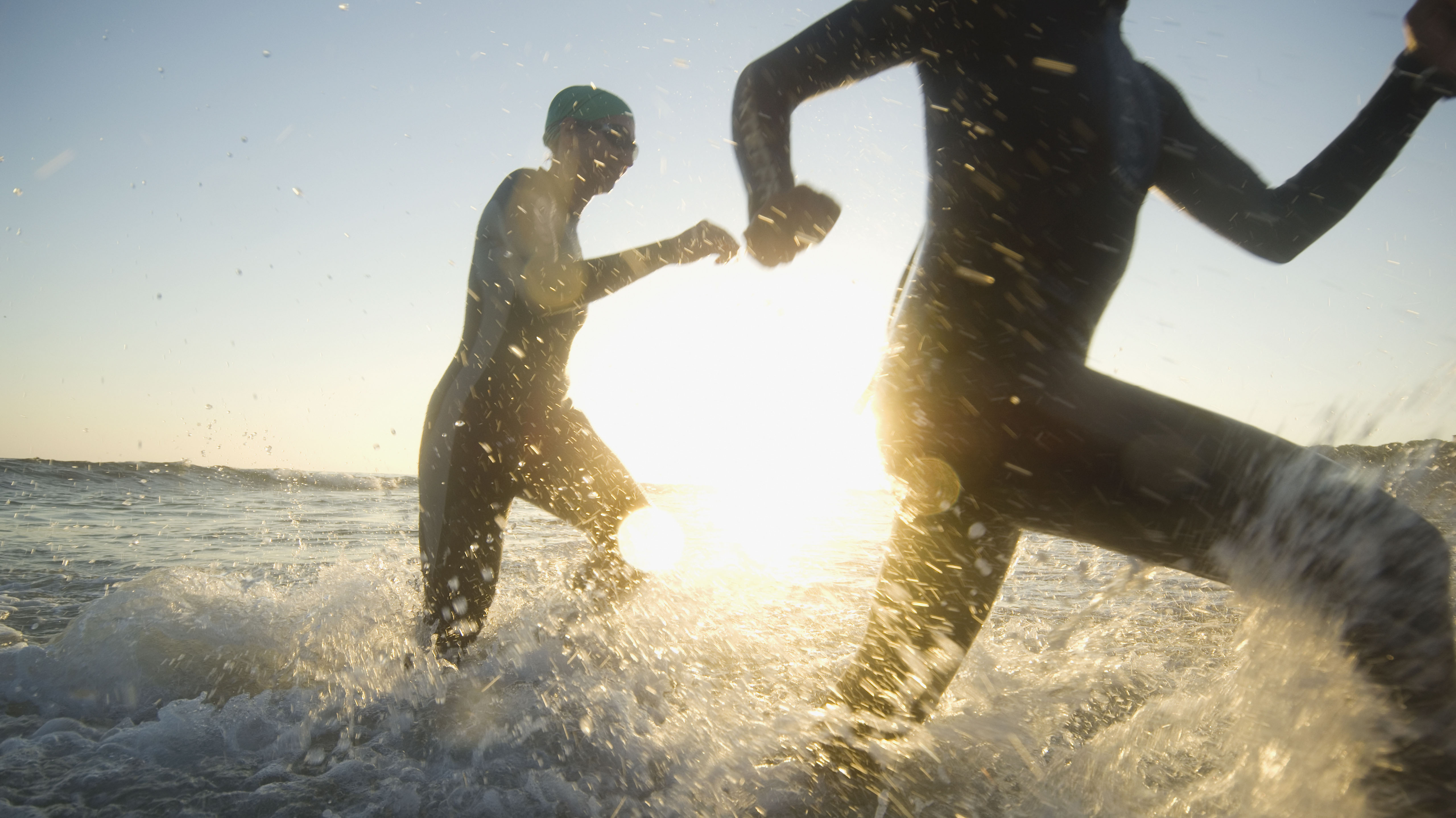 Swimmers running in surf