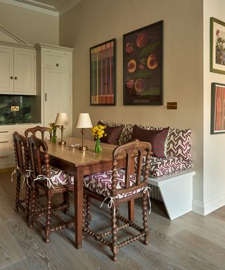 bench seat and dining table with art above
