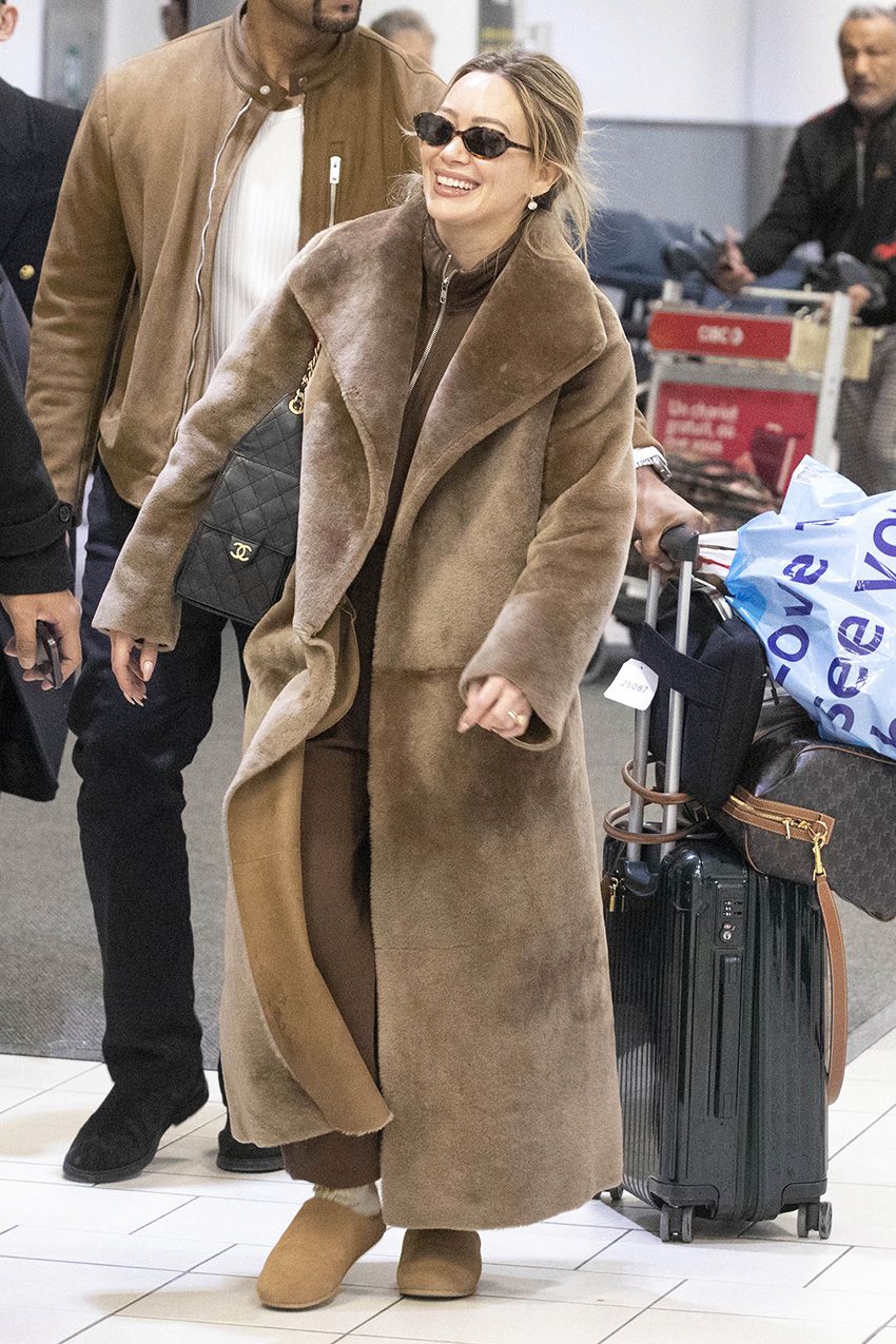 Hilary Duff wearing a brown outfit at the airport in Toronto