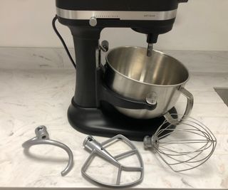 KitchenAid 5.6L Bowl Lift Stand Mixer with its attachments, sitting on a marble surface