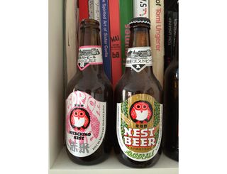 Japanese Hitachino Nest beer bottles take pride of place on Jullien's bookshelf