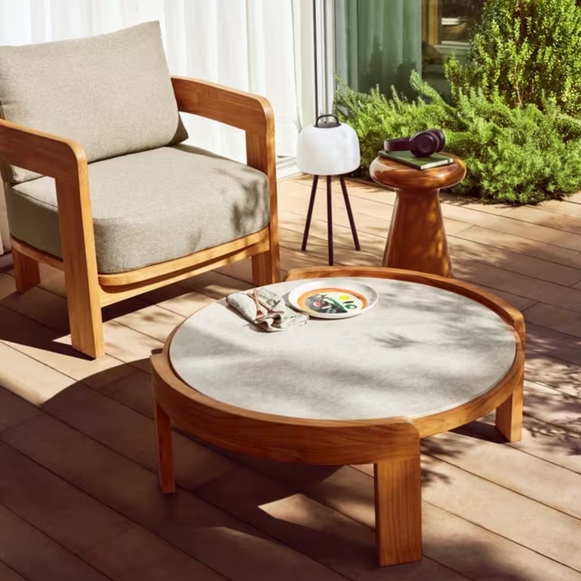 John Lewis Terra teak garden chair and coordinating coffee table on a sunny patio