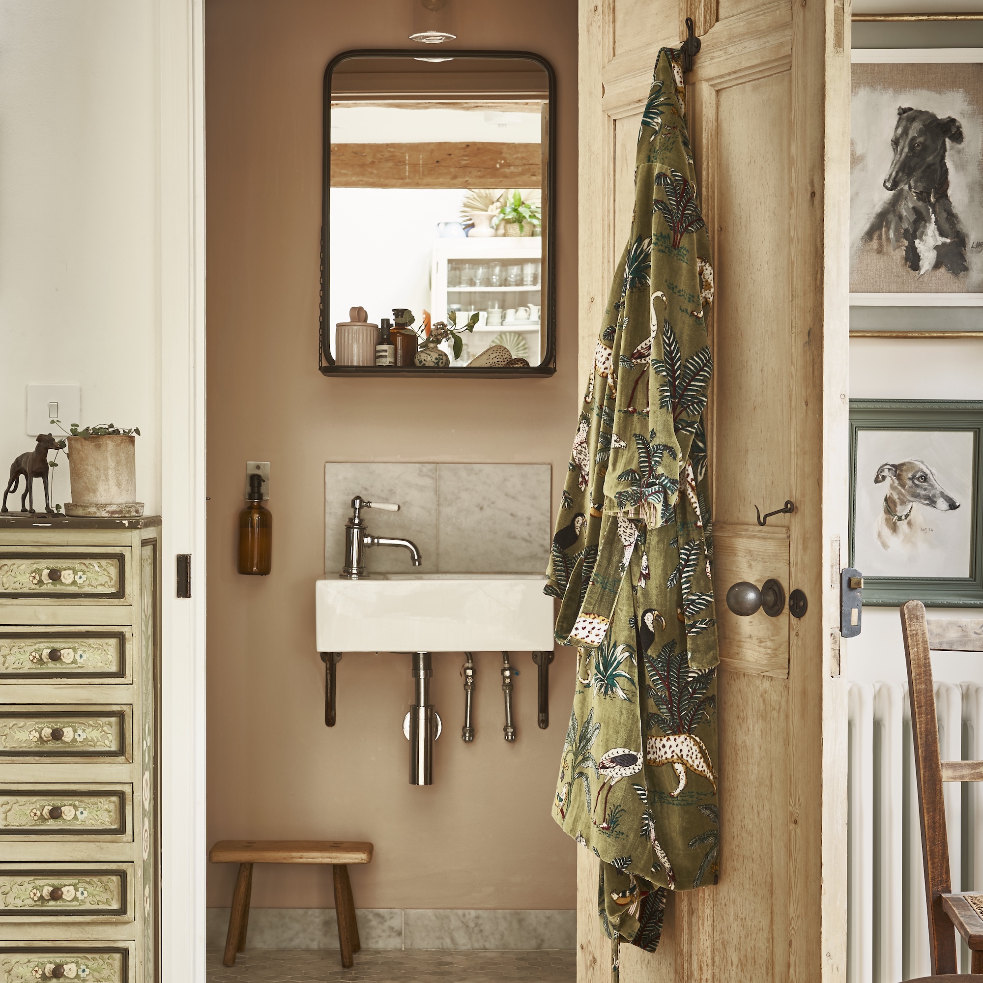 small bathroom with wall-hung basin with mirror above