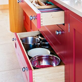 red kitchen with open drawers